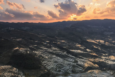 Aerial view of landscape against sky during sunset