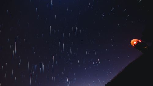 Low angle view of illuminated lights at night