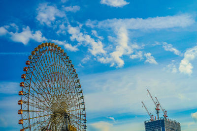 Low angle view of ferris wheel against sky