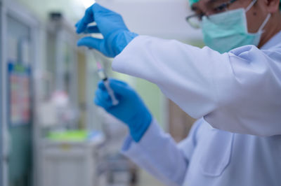 Midsection of person holding umbrella