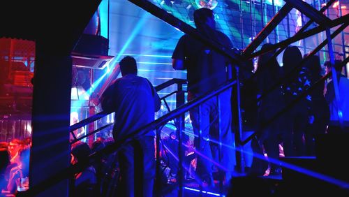 People standing in illuminated nightclub