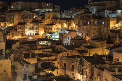 High angle view of illuminated buildings in city at night