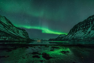 Scenic view of lake against sky at night