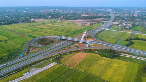 High angle view of agricultural field in city against sky