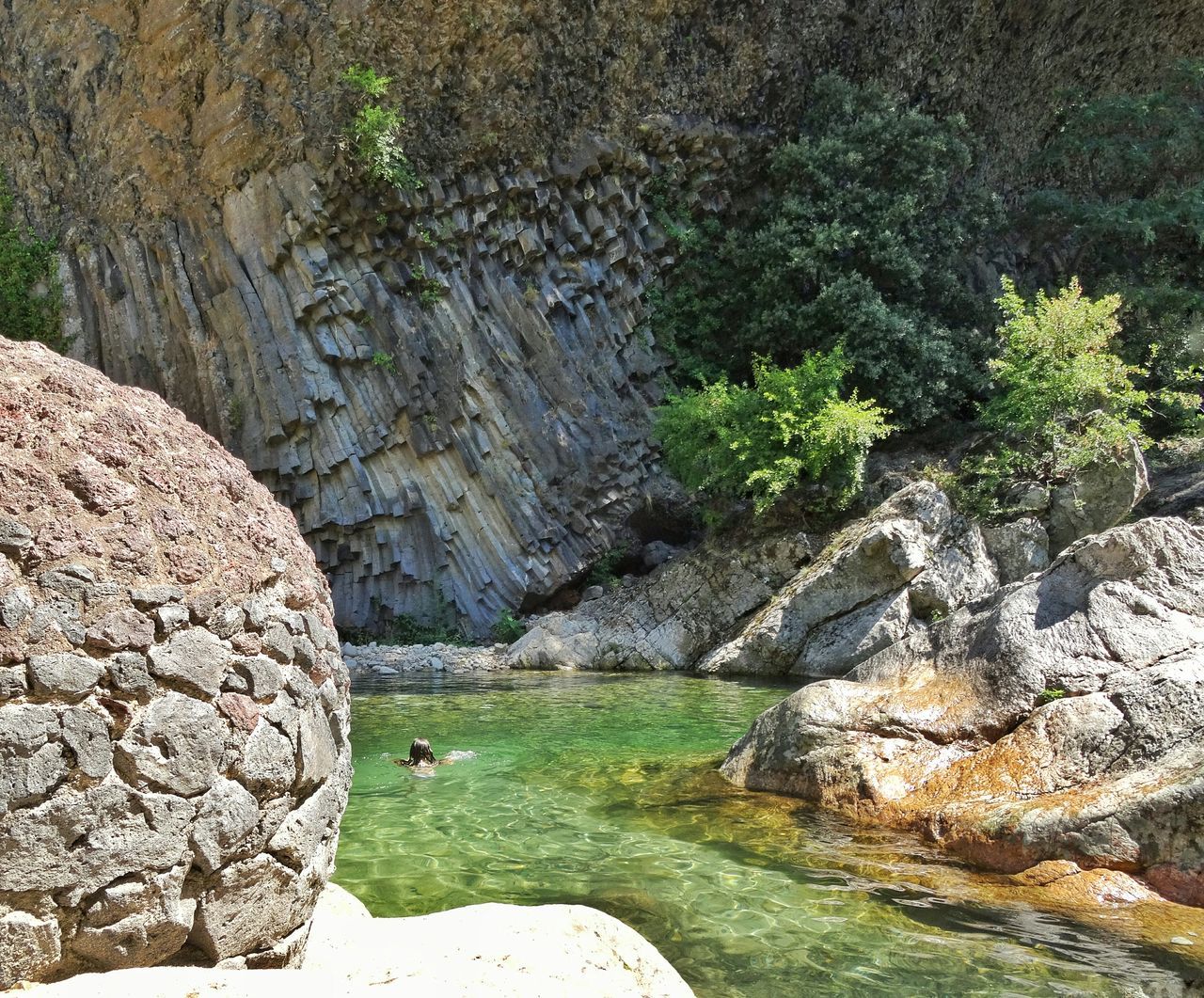 rock - object, water, rock formation, tranquility, tranquil scene, rock, nature, beauty in nature, scenics, tree, cliff, stone, river, non-urban scene, rough, idyllic, moss, day, outdoors, growth