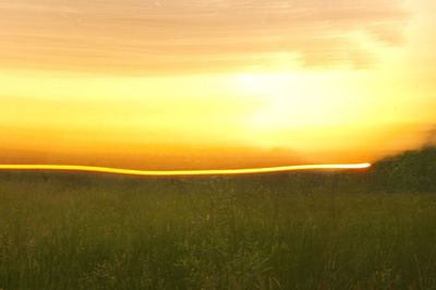 Scenic view of field against sky during sunset