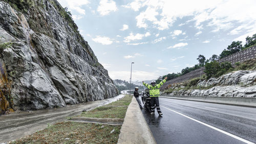 Road passing through mountain against sky