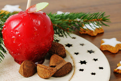 High angle view of cookies with caramelized apple in plate on wooden table