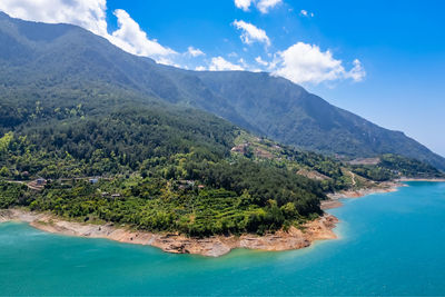 Scenic view of sea and mountains against sky