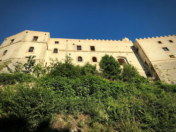 Low angle view of historic building against clear blue sky