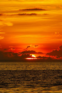 Scenic view of sea against romantic sky at sunset