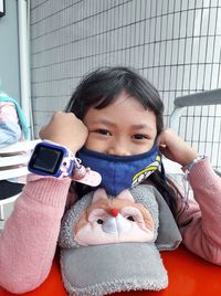 Portrait of cute girl holding camera