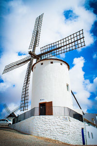 Low angle view of windmill against cloudy sky