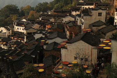High angle view of houses in town against sky