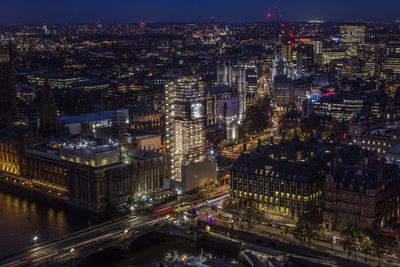 High angle view of city lit up at night