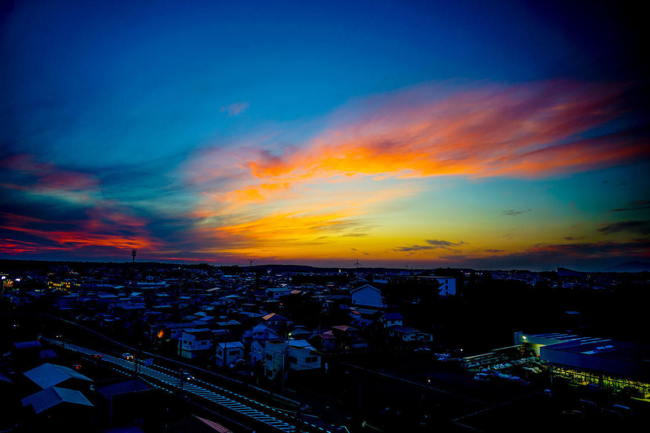 sky, horizon, cloud, city, architecture, sunset, cityscape, building exterior, dusk, built structure, nature, evening, transportation, high angle view, afterglow, no people, building, dramatic sky, city life, landscape, outdoors, illuminated, beauty in nature, travel destinations, night, mode of transportation, travel, scenics - nature, road, skyline, aerial view, street, reflection, blue, orange color, urban skyline, multi colored, environment