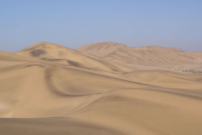 Scenic view of desert against clear sky