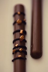 Close-up of colored pencils on table against white background
