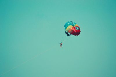 Low angle view of parachute against clear sky
