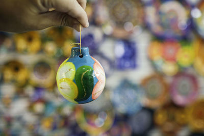 Cropped hand of woman holding christmas decorations