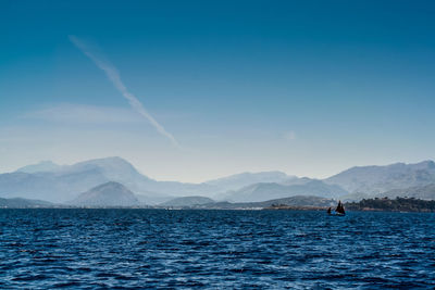 Scenic view of mountains against blue sky