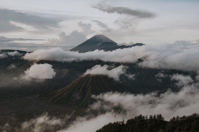 Scenic view of mountains against sky during foggy weather