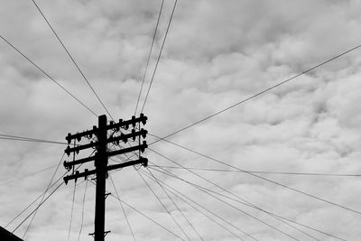 Low angle view of electricity pylon against sky