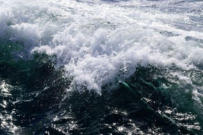 High angle view of waves splashing in sea