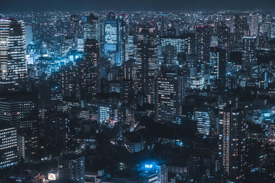 Illuminated modern buildings in city at night