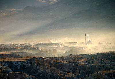 View of cityscape against cloudy sky