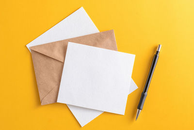 High angle view of pen on yellow table