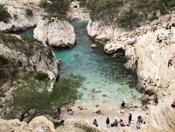 High angle view of people on rocks at beach