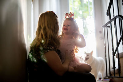 Mother and daughter sitting at home