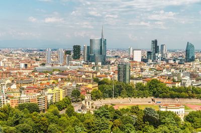 Aerial view of modern buildings in city against sky