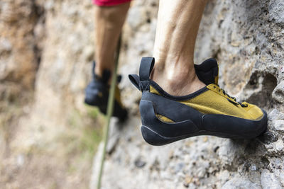 Low section of person walking on rock