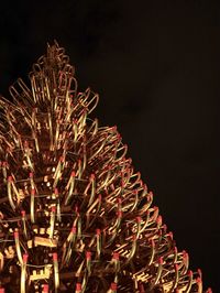 Low angle view of illuminated fireworks against sky at night