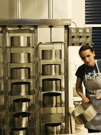 Full length of young man standing in factory