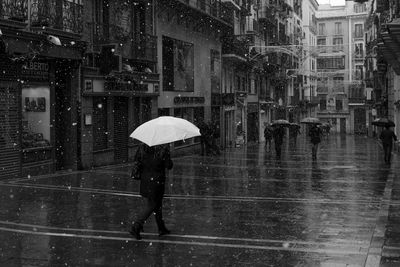 People walking on wet footpath during winter