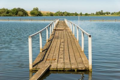 Pier over lake against sky