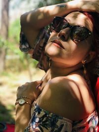 Close-up portrait of young woman wearing sunglasses