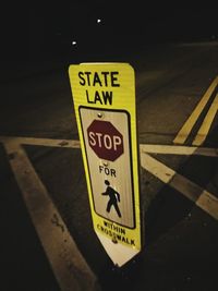 Close-up of road sign at night