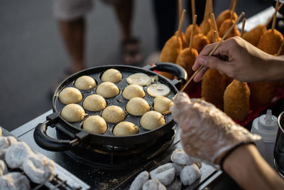 Cropped hand of man preparing food