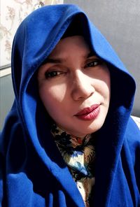 Portrait of mature woman wearing blue hooded shirt
