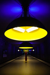 Rear view of man in illuminated subway