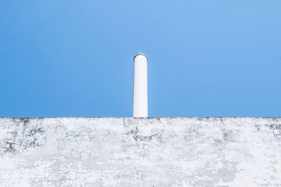 Low angle view of lighthouse against clear blue sky