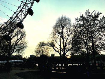 Low angle view of silhouette trees against sky