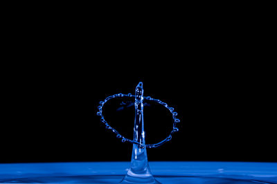 Close-up of water splashing against black background