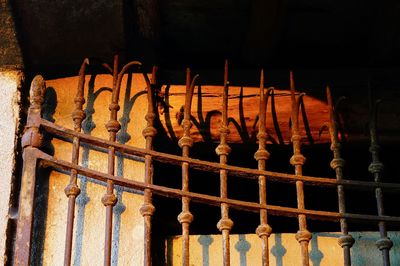 Metal structure hanging by railing against building