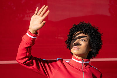 African american woman with short hair and urban dress with red background