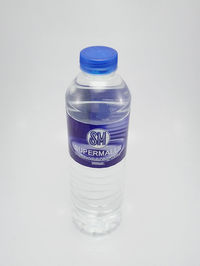 Close-up of glass bottle against white background